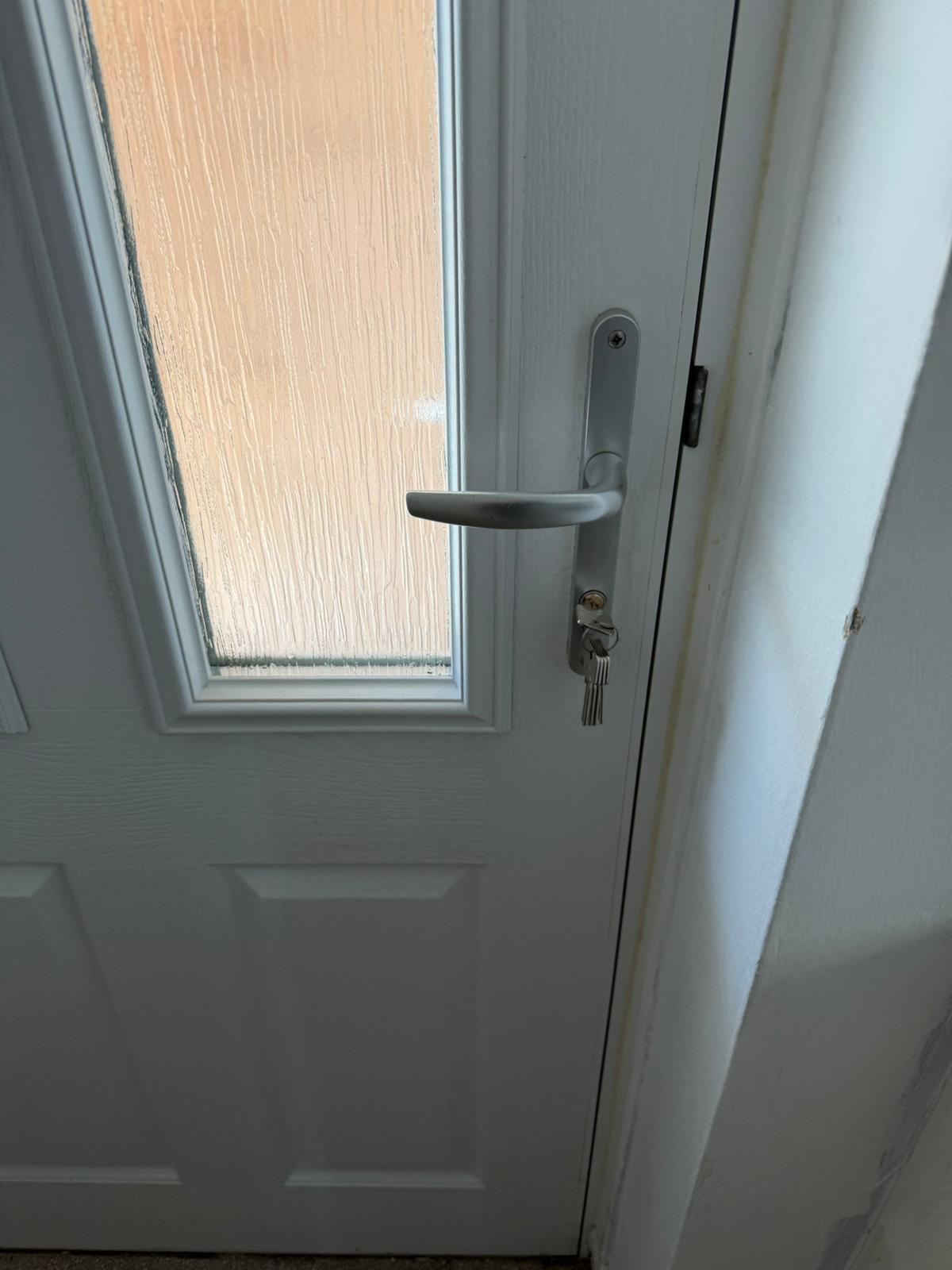 White composite front door with new chrome handle, euro cylinder and cut keys